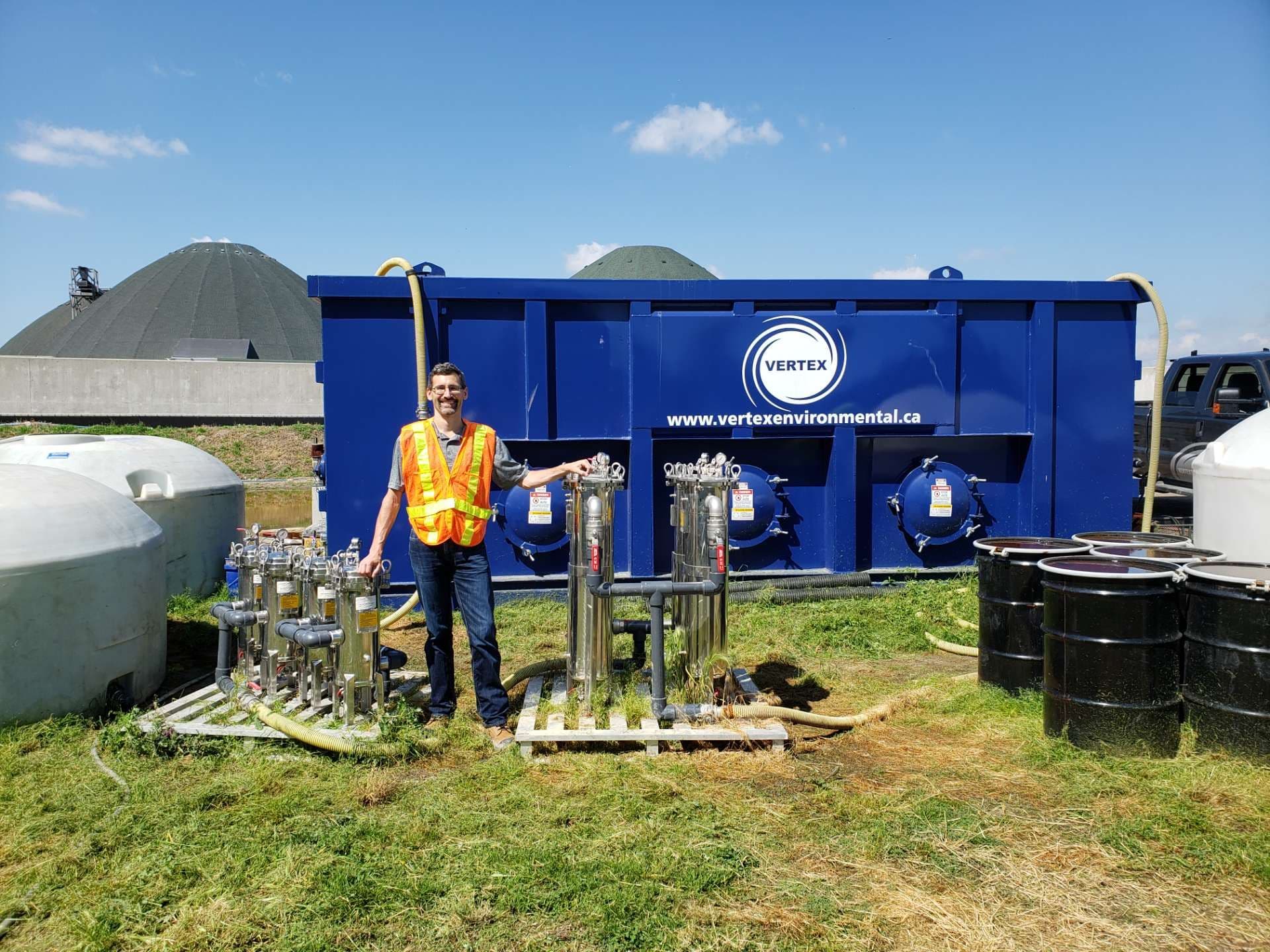 Bruce Tunnicliffe of VEI standing next to groundwater remediation recirculation system equipment