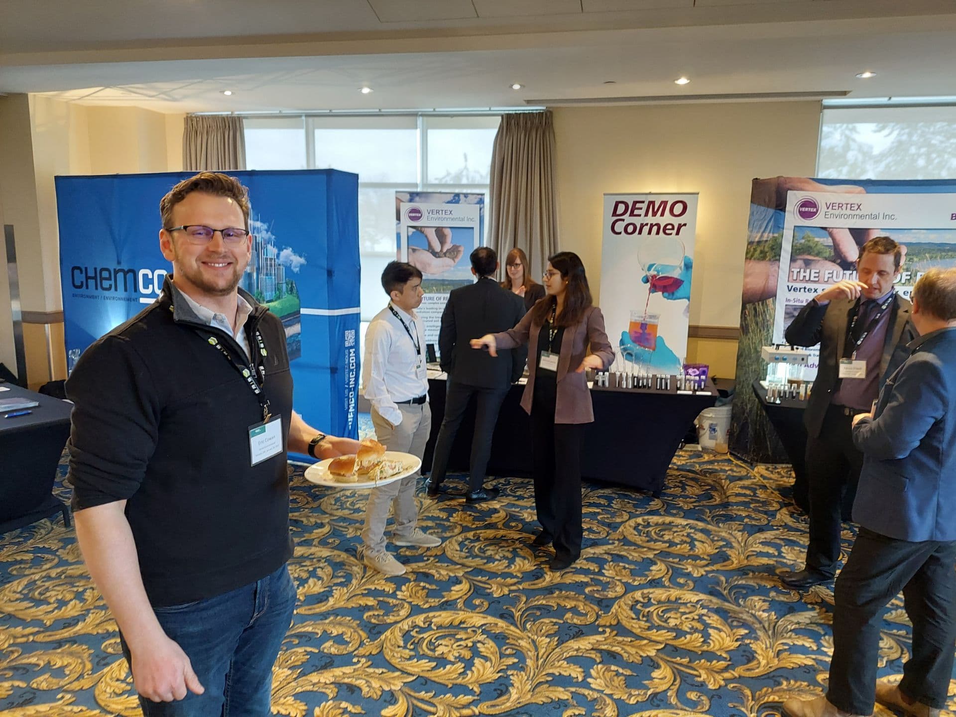 Demo corner with people standing around the company stand at SMART Remediation event